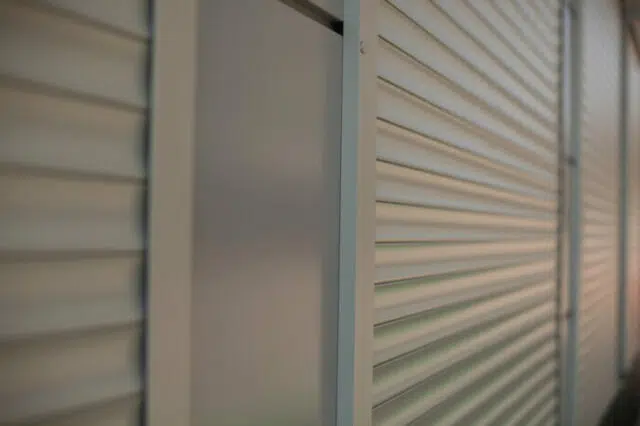 The surface of the blinds on the shop windows. Refracted plastic surface.