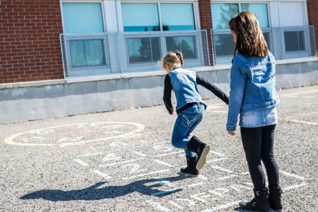 Hopscotch on the schoolyard with friends play together