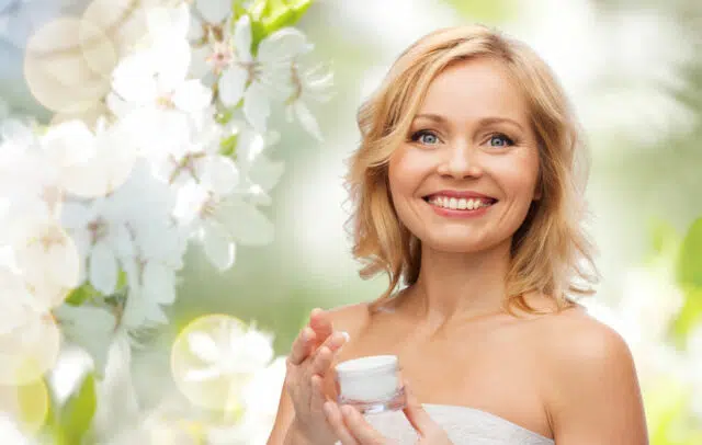 happy woman with cream jar