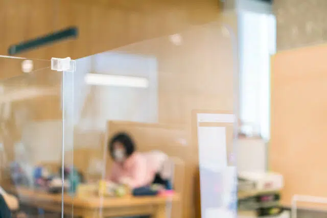 Acrylic plexiglass separator setting on the desk in the office w