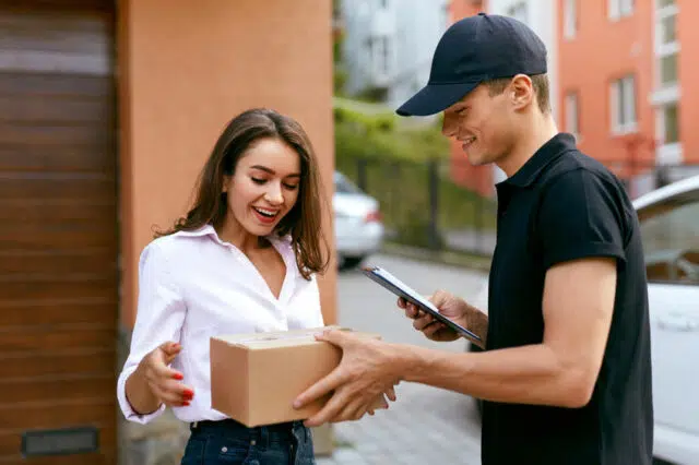 Express Delivery Service. Courier Delivering Package To Woman
