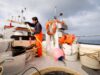 Fisherman hosing down fishing boat
