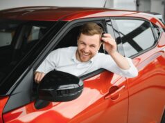 Man buying a car at a showroom