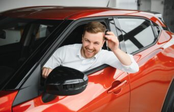 Man buying a car at a showroom