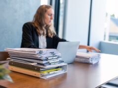 Businesswoman Working with Stacks of Documents