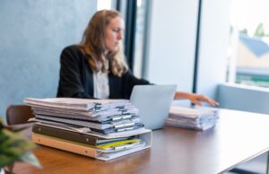 Businesswoman Working with Stacks of Documents