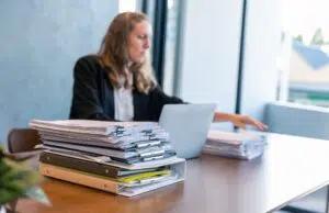 Businesswoman Working with Stacks of Documents