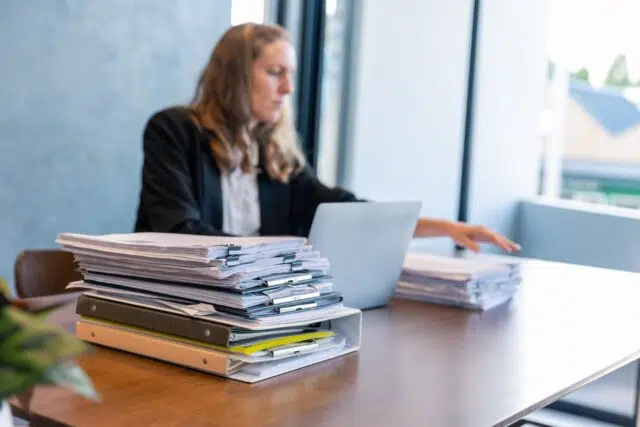 Businesswoman Working with Stacks of Documents Businesswoman Working with Stacks of Documents