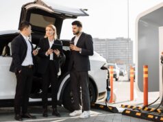 Multiracial businesspeople refilling EV at charging location