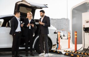 Multiracial businesspeople refilling EV at charging location