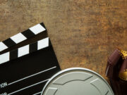 Clapper board with film reel.