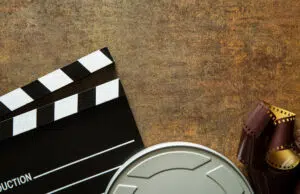 Clapper board with film reel.