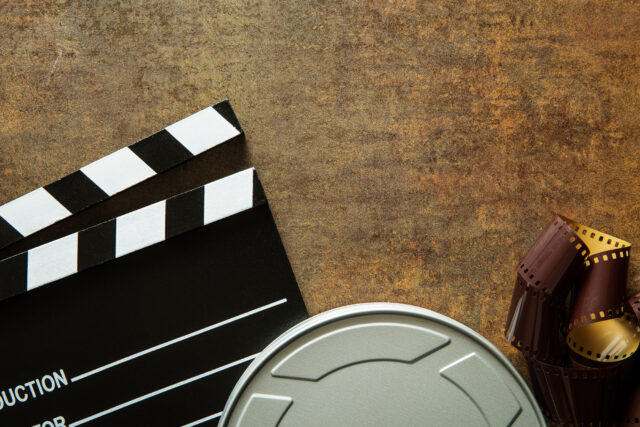 Clapper board with film reel. Clapper board with film reel.