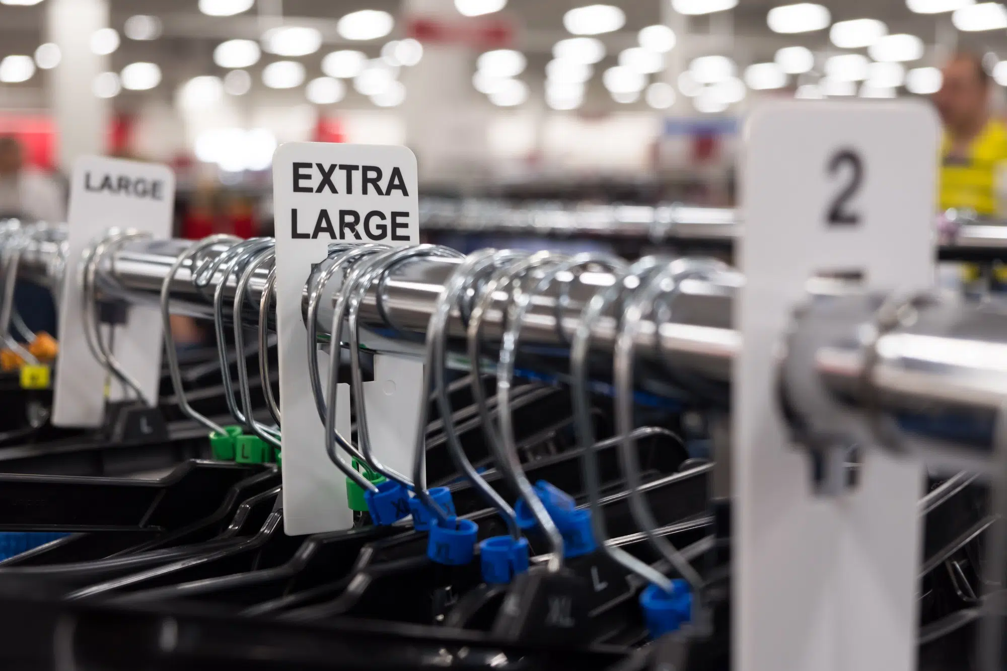 Close up of a clothing rack with extra large clothing size tags