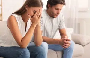 Depressed Couple Sitting Together After Break Up Conversation Indoor