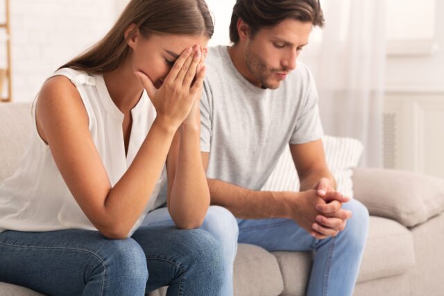 Depressed Couple Sitting Together After Break Up Conversation Indoor Depressed Couple Sitting Together After Break Up Conversation Indoor