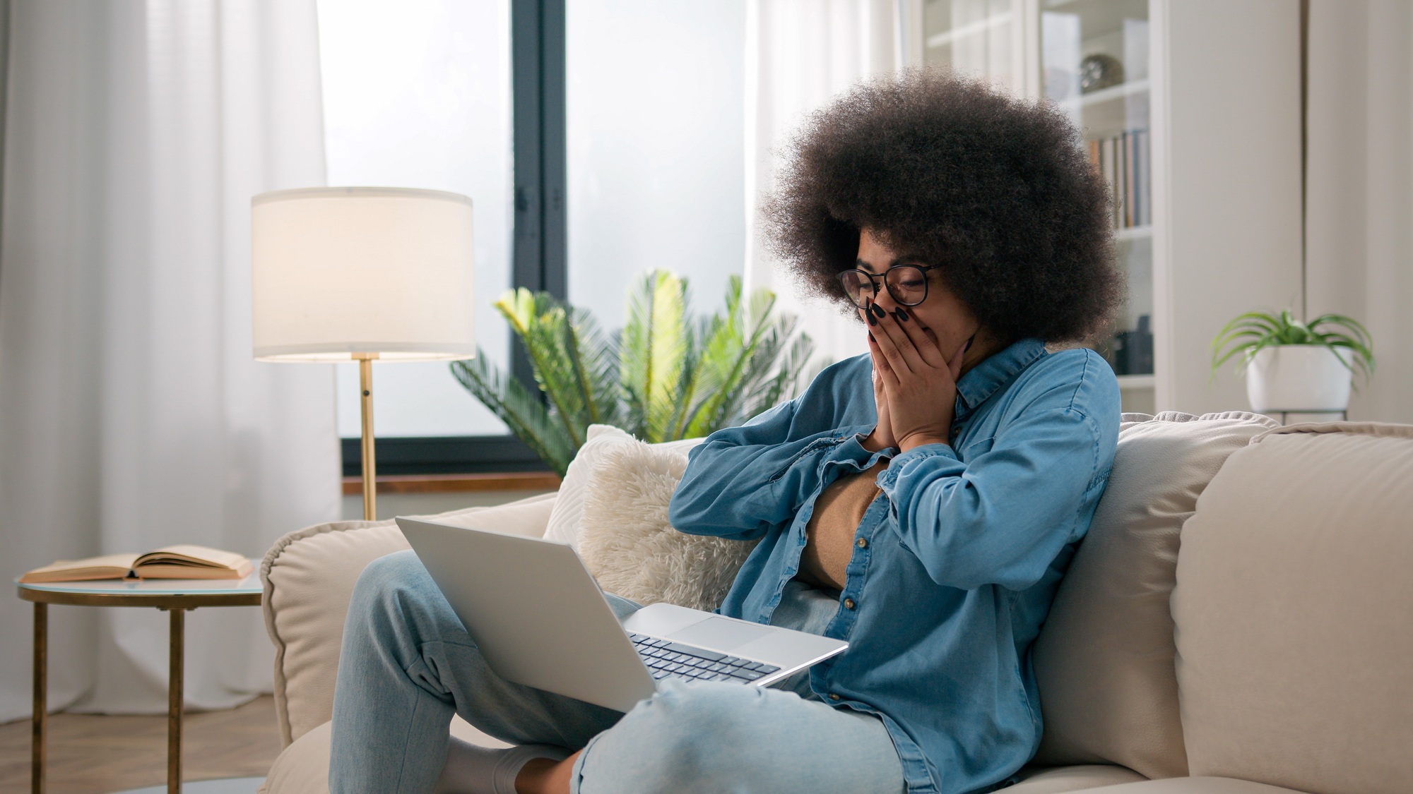Shocked amazed wonder African American girl with computer win online bet lottery achievement happy