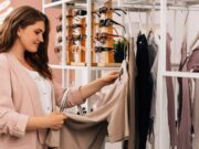 Side view of a smiling plus size woman shopping in a small clothing store