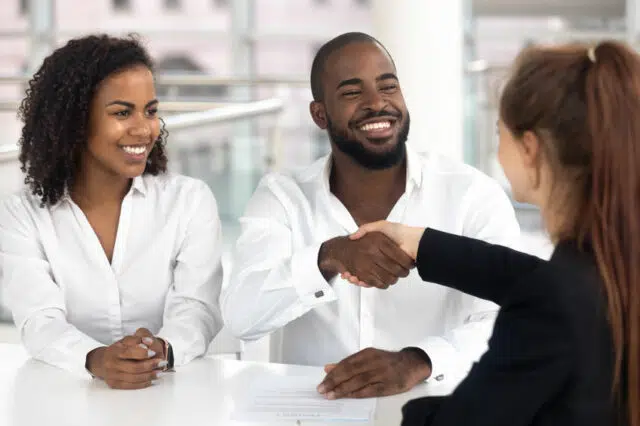 Happy black couple signing mortgage contract get new house keys