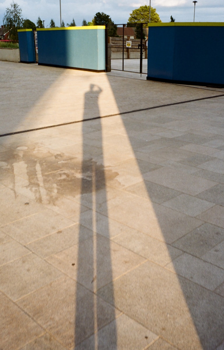 a shadow of a person on a concrete surface