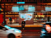 time lapse photography of man sitting on ledge smoking during night time